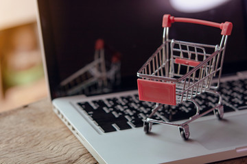 Shopping online concept - Empty shopping cart or trolley on a laptop keyboard. Shopping service on The online web. offers home delivery..