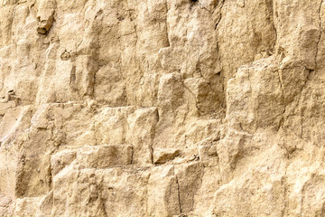 sandstone and clay wall covered with erosion and cracks