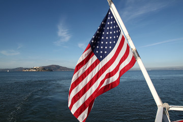 Usa flag on sea and The alcatraz island at San francisco,USA - Powered by Adobe