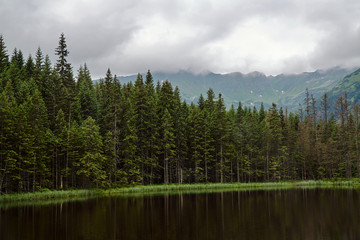 Post-glacial lake Smreczynski Pond in spring in the mountains of the Tatra Mountains in Poland.