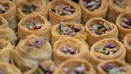 Baklava (modern Middle Eastern Arab-style dessert) baked with sugar and honey syrup, sweet and stuffed with almonds, nuts, chocolate or pistachios. In the old market, Jerusalem.