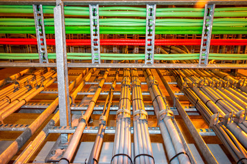 Electrical grey cables mounted in a rack for power supply in a industrial area