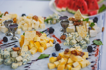 Beautifully decorated catering banquet table with assortment variety of different food snacks and appetizers on corporate christmas birthday party event or wedding celebration