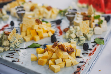 Beautifully decorated catering banquet table with assortment variety of different food snacks and appetizers on corporate christmas birthday party event or wedding celebration