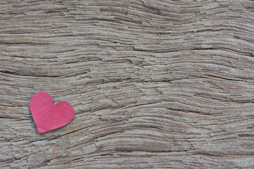 Valentines Day background with red heart shape on dark wooden background with copy space.