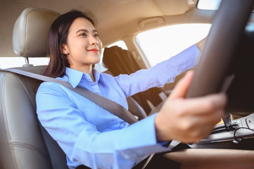 Fototapeta na wymiar businesswoman, work, driving, multitasking, car, lifestyle concept. Businesswoman multitasking while driving car working and talking on cell phone on the road.