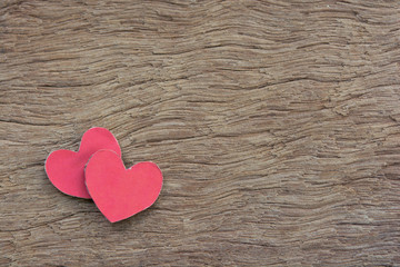 Fototapeta premium Valentines Day background with red heart shape on dark wooden background with copy space.