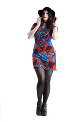 Fototapeta premium beautiful female fashion model wearing a stylish glamour dress is posing in various positions in the photo studio. white background in isolated space. elegant lifestyle with luxury appeal 