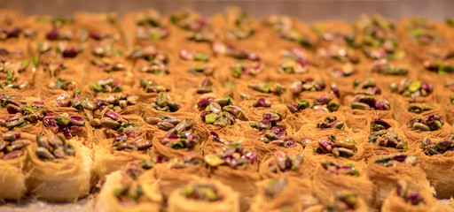 Baklava (modern Middle Eastern Arab-style dessert) baked with sugar and honey syrup, sweet and stuffed with almonds, nuts, chocolate or pistachios. In the old market, Jerusalem.