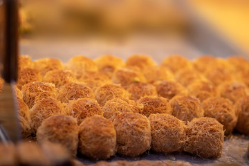 Baklava (modern Middle Eastern Arab-style dessert) baked with sugar and honey syrup, sweet and stuffed with almonds, nuts, chocolate or pistachios. In the old market, Jerusalem.