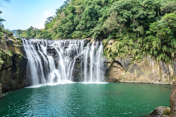 Fototapeta na wymiar Shihfen Waterfall, Fifteen meters tall and 30 meters wide, It is the largest curtain-type waterfall in Taiwan