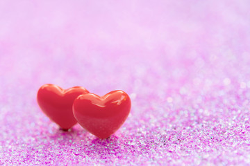 Fototapeta premium Valentines Day background with Red heart shapes on abstract light pink glitter background, Copy space