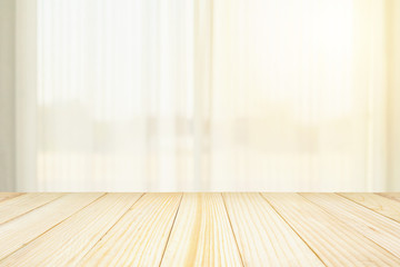 Empty wood table top with blur white curtain window and green garden background for product display template