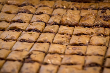 Baklava (modern Middle Eastern Arab-style dessert) baked with sugar and honey syrup, sweet and stuffed with almonds, nuts, chocolate or pistachios. In the old market, Jerusalem.