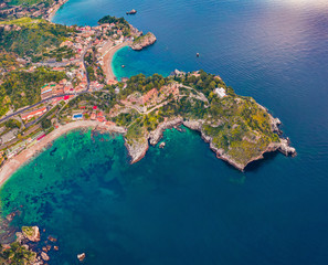 Fototapeta premium Straight-down view from flying drone. Aerial morning view of Bella island. Colorful spring seascape of Mediterranean sea, Mazzaro' town, Sicily, Itale, Europe. Traveling concept background.