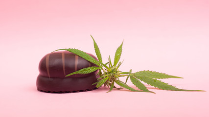 chocolate marshmallows with THC content on pink background. marijuana food, recreational soft drugs