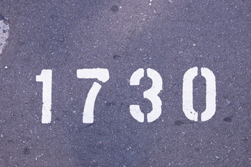 Number 1650 stenciled on the asphalt in white paint.