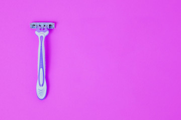 New disposable razor for safe shaving of female skin. Razor for a smooth shave on a bright background. Top view, copy space.