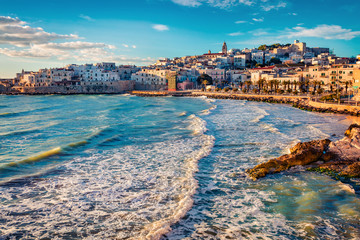Stormy morning cityscape of Vieste town. Stunning spring cescape of Adriatic sea, Gargano National Park, Apulia region, Italy, Europe. Traveling concept background.