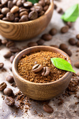 Coffee background. Coffee beans and ground powder on a stone concrete tabletop.