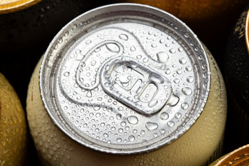 beer in cans in drops of water