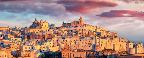 Panoramic morning cityscape of Ostuni town. Fantastic sunrise in Apulia, Italy, Europe. Traveling concept background. - obrazy, fototapety, plakaty