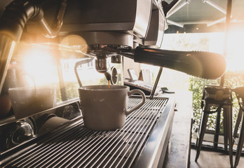 Close-up of espresso pouring from coffee machine by Professional coffee brewing.