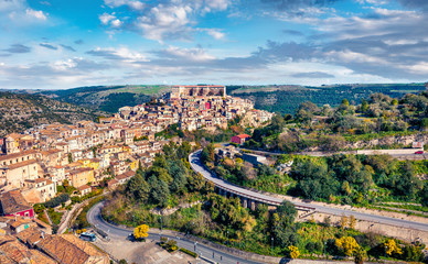 Colorful spring cityscape of Ragusa town with Palazzo Cosentini and Duomo di San Giorgio church on background. Gorgeous afternoon scene of Sicily, Italy, Europe. Traveling concept background.
