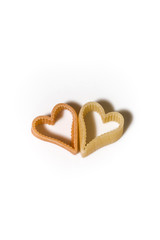 heart-shaped pasta on a white background, vertical