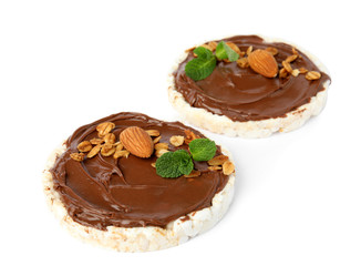 Puffed rice cakes with chocolate spread, nuts and mint isolated on white
