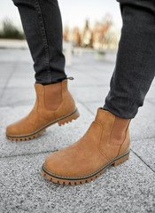 man standing in light suede boots