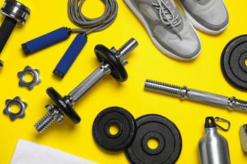 Gym equipment on yellow background, flat lay