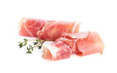Slices of tasty prosciutto on white background