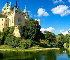 Fototapeta na wymiar Bojnice Castle, a romantic castle in the middle of Slovakia, towers and a beautiful park with trees around Europe travel