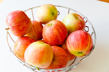 Bowl of apples red-yellow variety Gala sweet fruit full of vitamins fiber minerals and sweet juice.
