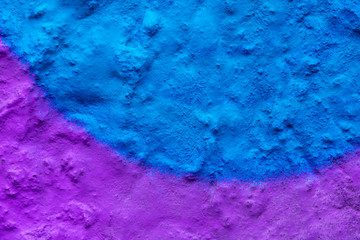 Beautiful street art graffiti background with copyspace. Abstract geometric spray drawing fashion colors on the brick wall. Urban Culture detailed close up texture purple, crimson ,blue picture