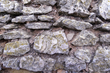 Historic stones. Rough natural masonry with wide seams on a medieval watchtower. Light rough stone.