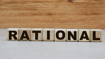 Fototapeta na wymiar concept of the word rational on cubes on a wooden background