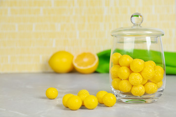 Delicious lemon drops on grey table. Space for text