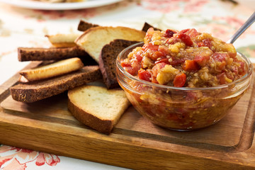 Eggplant caviar in the glass bowl and rye bread. Сloseup