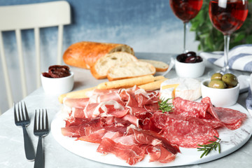Tasty prosciutto served on light grey marble table