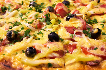 Close up view of fresh and very tasty pizza with olives and tomatoes