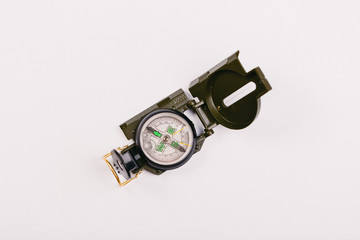 metal navigation travel compass on a light gray background. search for a way. point of view