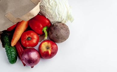 vegetables from the store in a paper bag on a white background with copy space for your text