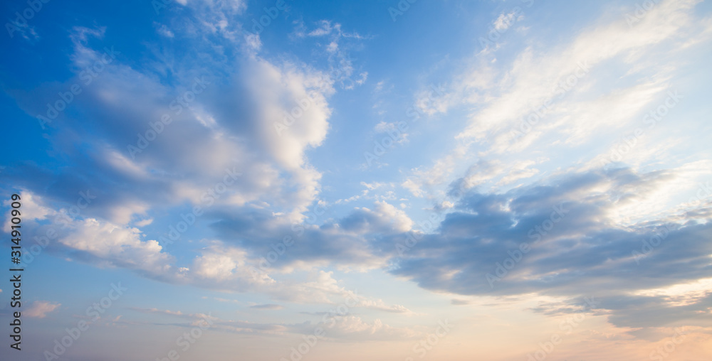 Wall mural blue sky clouds background. beautiful landscape with clouds and orange sun on sky