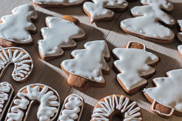 Handmade festive gingerbread cookies in the form of stars,staff,Christmas trees.on a light countertop.