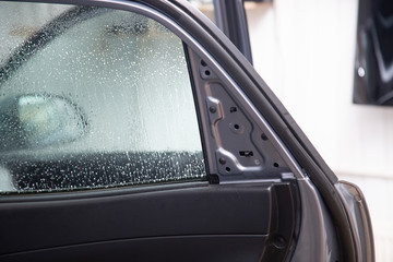 Installation of window film on car Windows. Protection from UV light.