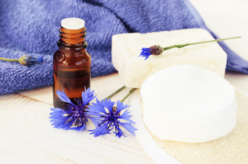Centaurea flower essence, healing herb for health care and beauty. Blue cornflower, glass dropper bottle of essential oil closeup, bathroom accessories.
