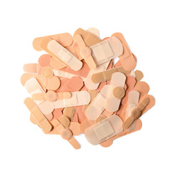 Different medical sticking plasters isolated on white, top view. First aid item