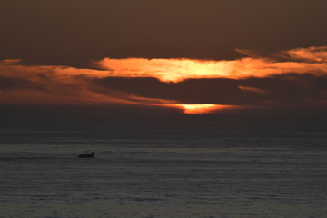 Small Fishing Boat Under an Orange Sunset, Morocco
